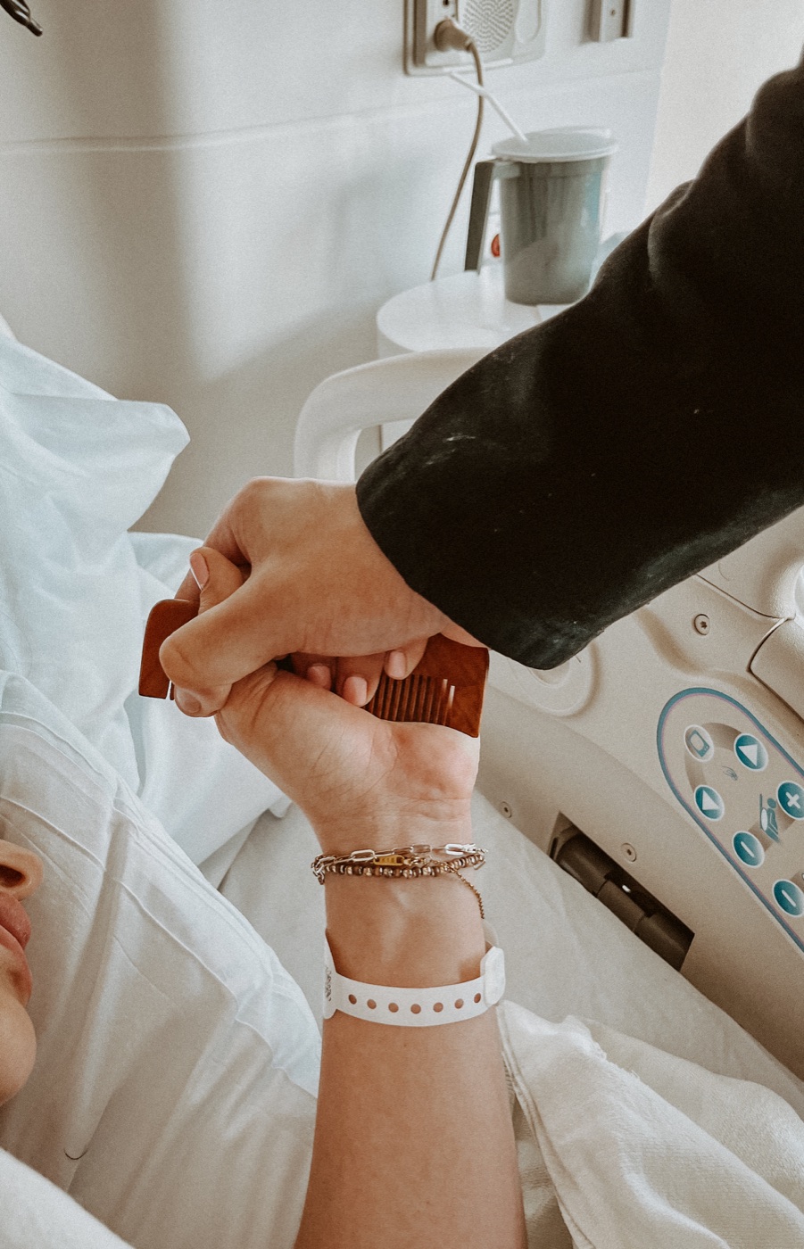 Mother gripping a wooden comb during labor for comfort