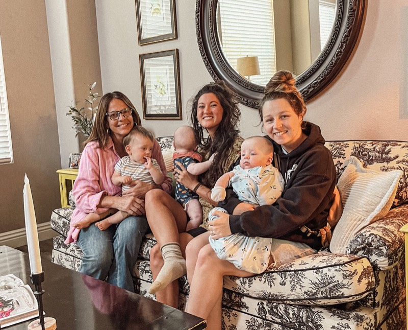 Juliana with mothers and their babies on a couch